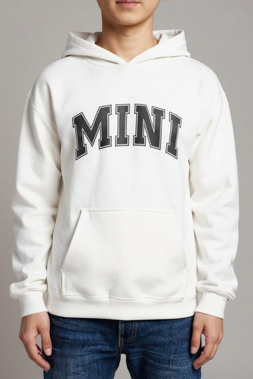 White hoodie with 'MINI' text worn by a person on a gray background